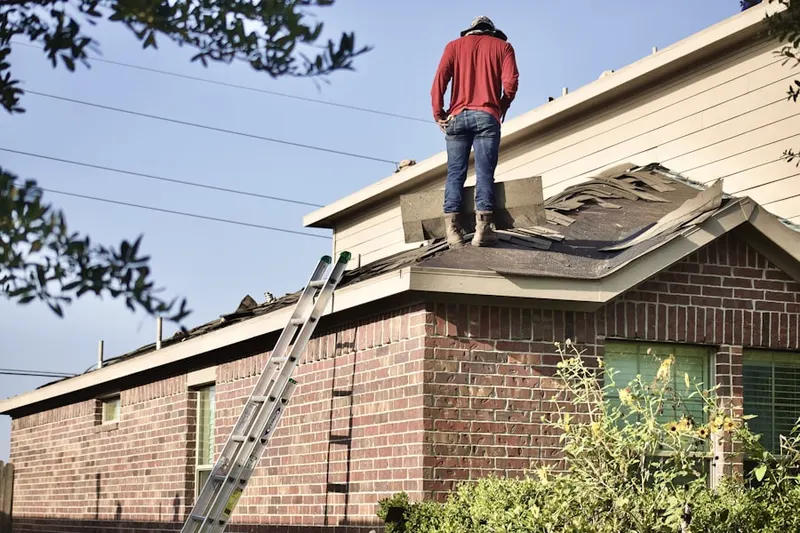 Professional roofer working on a residential roof in Woodcreek Oaks